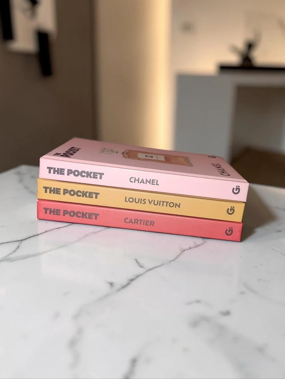 Louis Vuitton, Cartier, and Chanel decorative pocket books